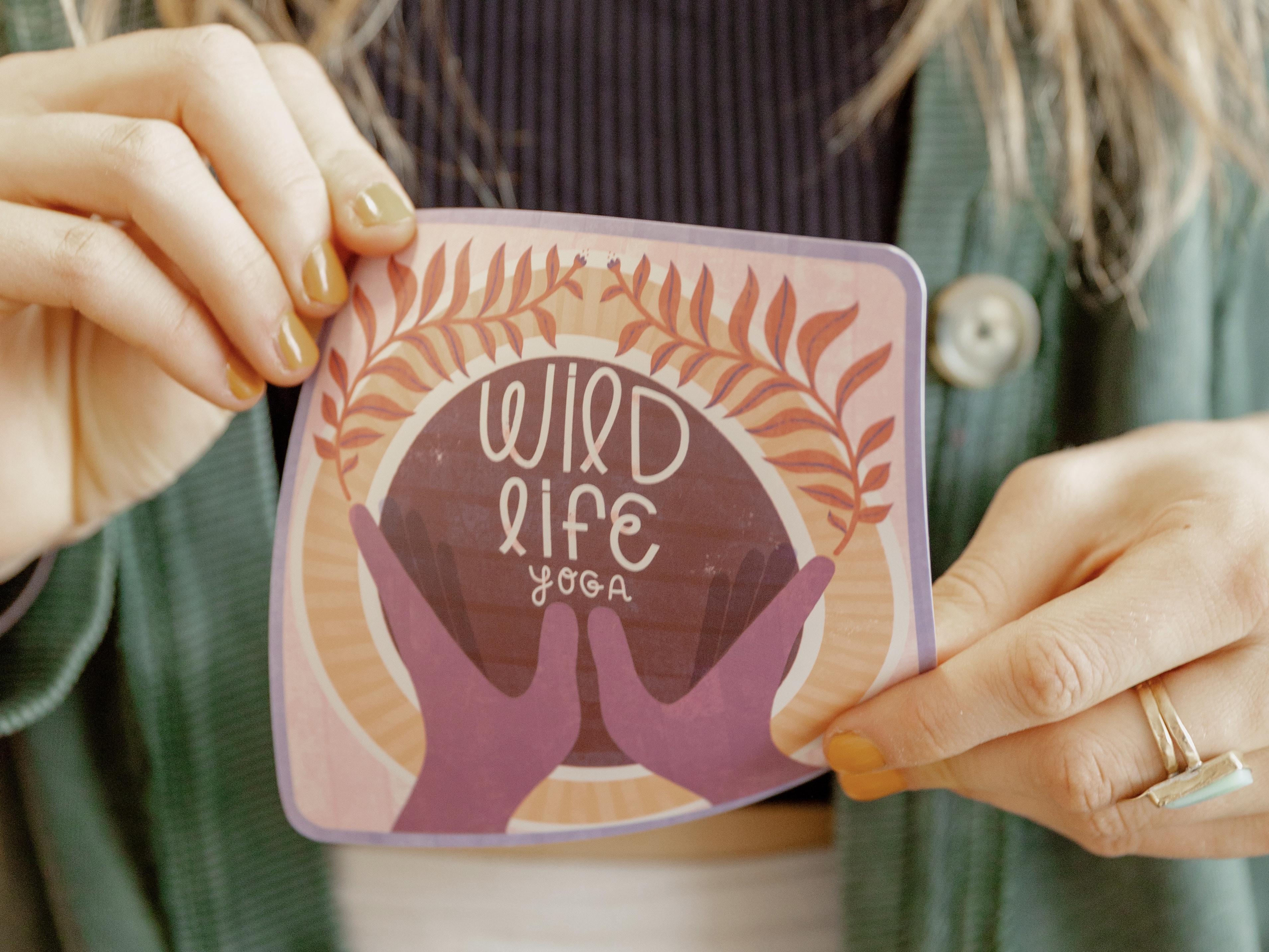 person holding a card showing how flexible the card can be while remaining sturdy. the card is very durable. 